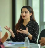 middle-eastern-woman-explains-new-strategy-her-colleagues-presentation-startup-office